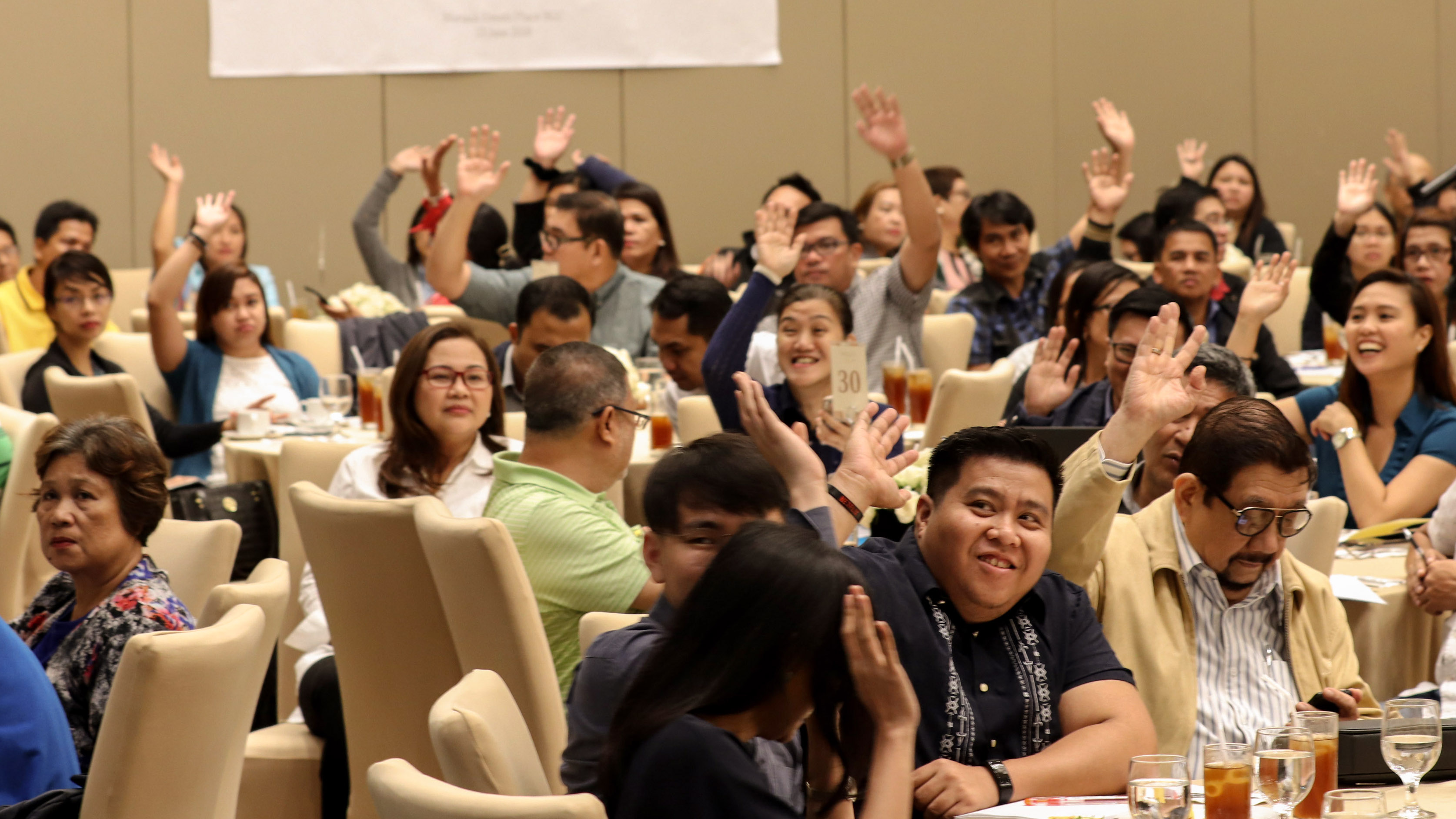 ENERGIZED: Stakeholders raise their hands, demonstrating their active involvement in the crafting of new guidelines during the Public Consultation on 13 June. Attendees included representatives from various generation companies and LGUs from Luzon, Visayas and Mindanao.