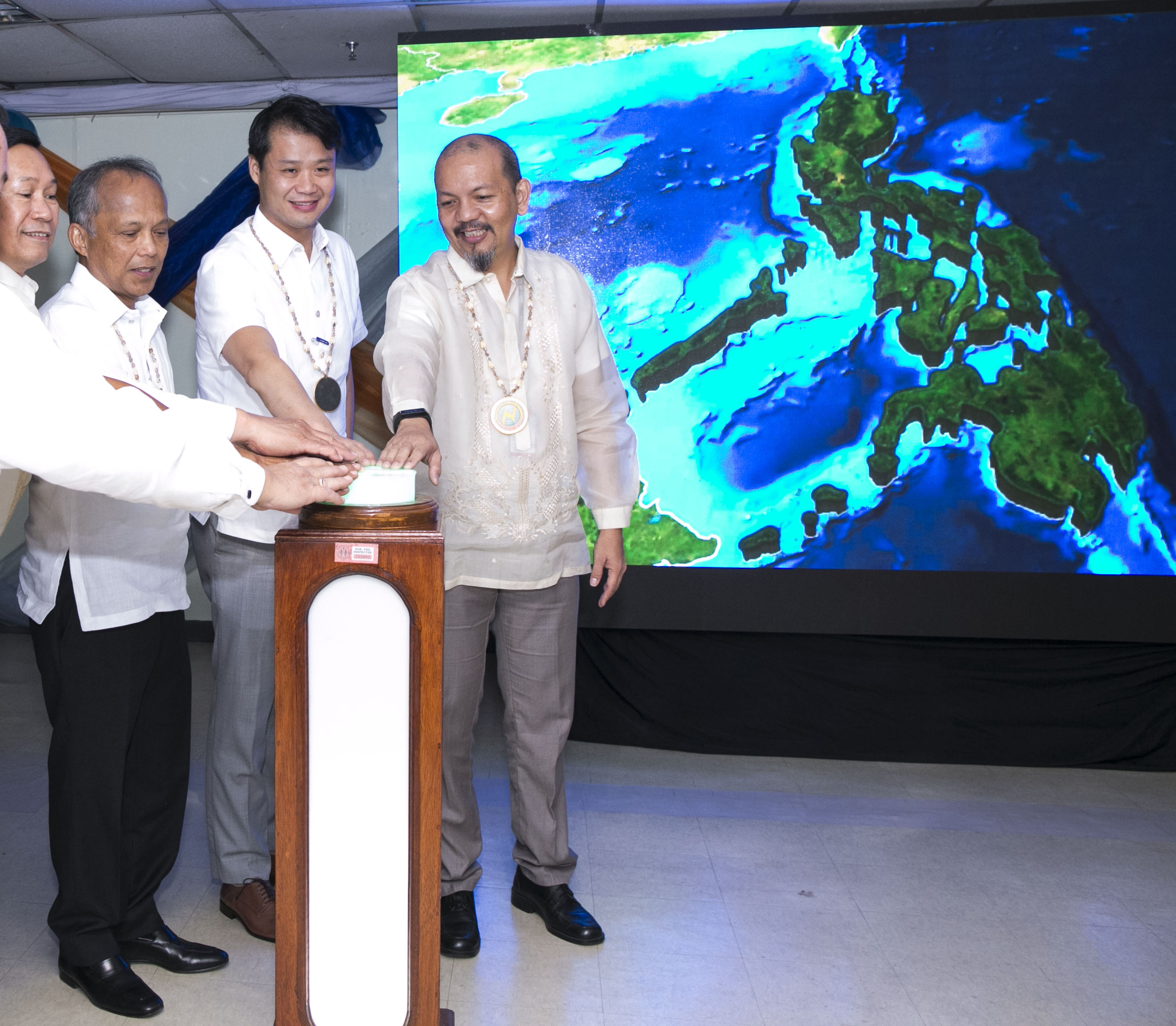 (QUEZON CITY). 12th MILLION - NEA Administrator Edgardo Masongsong, Energy Secretary Alfonso G. Cusi, Senate Committee on Energy Chair Senator Sherwin Gatchalian and Asec Jonas Soriano from the Office of the Cabinet Secretary jointly switch the ceremonial lighting of the 12 millionth consumer connection in Tandag City under the coverage area of the Davao del Norte Electric Cooperative during the opening ceremonies today August 2 2017 of the 8th National Electrification Awareness Month and the 48th NEA Found