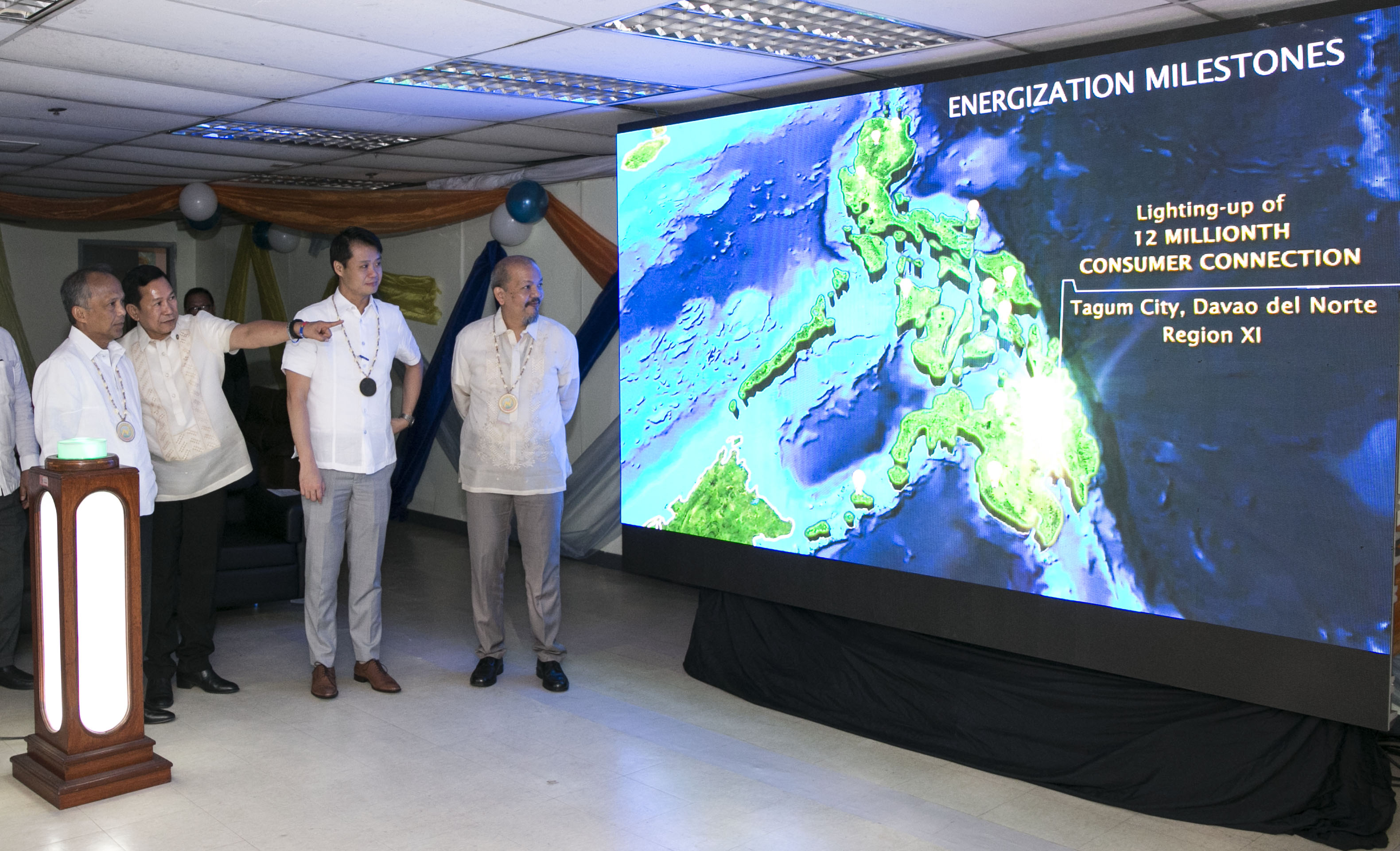 (QUEZON CITY). POWERED UP. National Electrification Administration (NEA) Administrator Edgardo Masongsong briefs Energy Secretary Alfonso Cusi, Senator Sherwin T. Gatchalian and Assistant Secretary Jonas Soriano from the Office of the Cabinet Secretary about the location of the 12 millionth consumer connection energized under the government's Rural Electrification Program in the opening ceremony of the 8th National Electrification Awareness Month and 48th NEA Founding Anniversary at the NEA Bldg., in Quezon